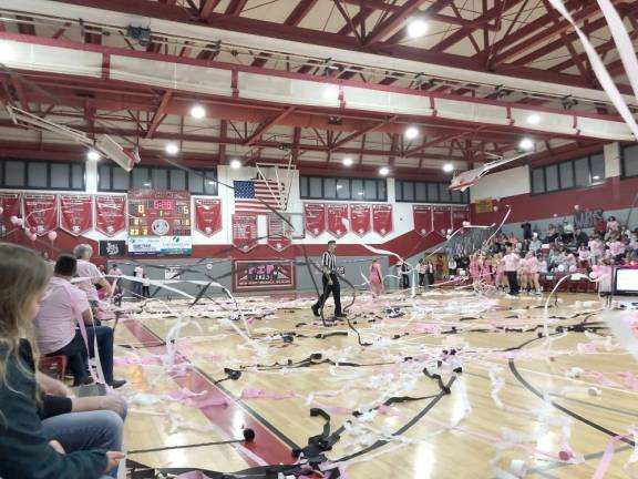 The crowd throws streamers after the first basket is scored during the Pretty in Pink varsity girls basketball game at High Point Regional High School on Saturday, Jan. 14.