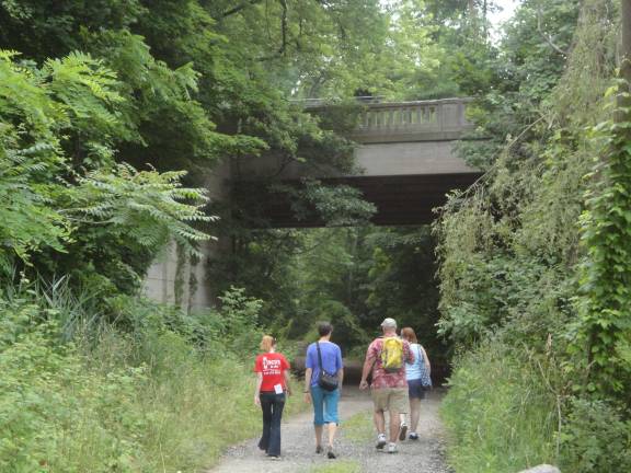 Councilman Dan Barr leads Preservation NJ senior program director Stephanie Cherry-Farmer, New Jersey Historic Trust preservation specialist Cathy Goulet and her assistant Lauren Giannullo down the former Susquehanna Western Railroad Line at the beginning of the historic tour.