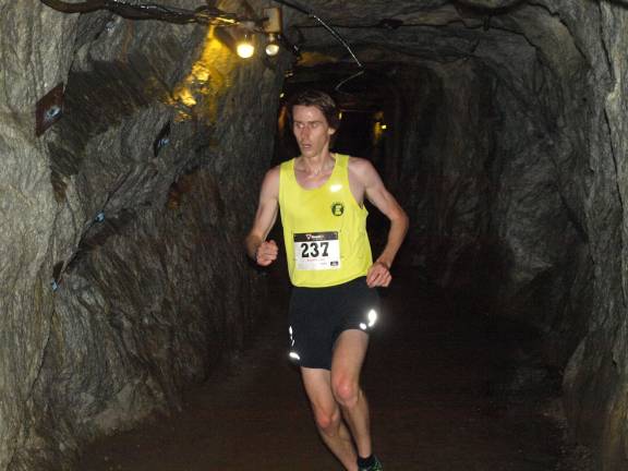 Overall winner Justin Scheid of Sparta runs on the underground portion of the Ogdensburg 5K race Saturday morning. His finishing time was 16:18.8.