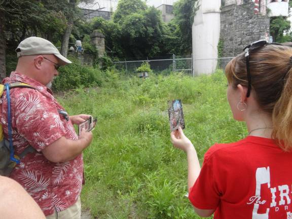 Councilman Dan Barr and program director Stephanie Cherry-Farmer compare old photographs of Gingerbread Castle to the way it looks today.