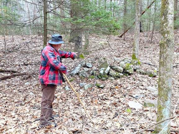 Dan Tassey points out a larger stone grouping.