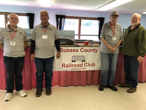 From left are Sussex County Railroad Club members Dave Rutan, Robert Winter and Noel Phillips. At right is Douglas MacRae, director of Grace’s Pantry, a food pantry based in Franklin. (Photo by Kathy Shwiff)