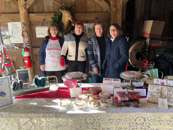 DAR members Kathy Cook, Bonnie Matthews, Joanne Cosh and All Burns manned the holiday bake sale.