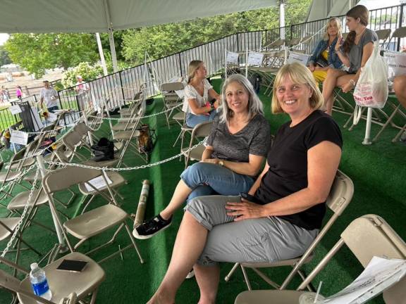 Lisa Petronaci and Trish Diesburg sit in the temporary box seats at the horse show arena. Behind them are, from left, Emily McCullough, Kim McCullough and Abigail Woods.