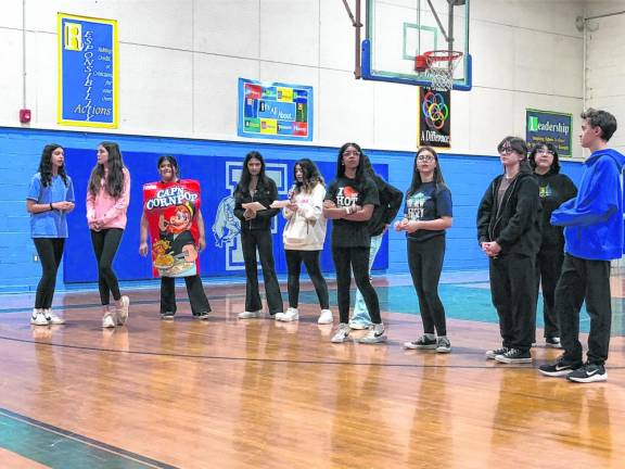 Members of the Franklin Borough School Student Climate Team speak to students in the gym. (Photo by Kathy Shwiff)