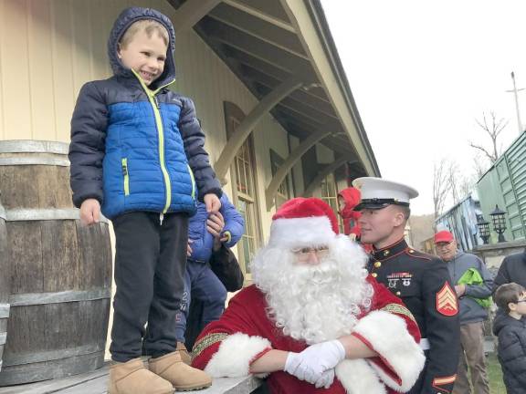 Jackson Langenbrunner, 5, of Green poses for a photo with Santa at the Sparta Station during Operation Toy Train’s stop there Saturday, Dec. 10.