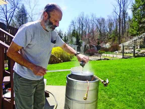 Photos by Scott Baker Franklin resident Mike Orloski adds finishing hops to the wort during the final five minutes of the boil.