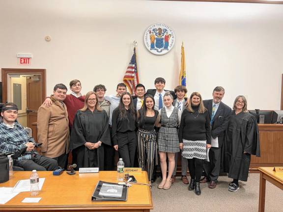 Members of the Pope John XXIII Regional High School mock trial team pose with their teacher-coach Laurie Lynch, lawyer-coach Michael Hanifan and the final-round judges, Janine Allen and Dina Mikulka.