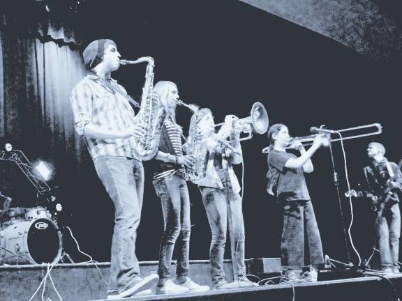 Photo by Scott Baker No Vertebrae horn section: Ian on tenor sax, Christina on alto sax, Allison on mellophone and Cara on trombone. Bassist Andrew is on the right.
