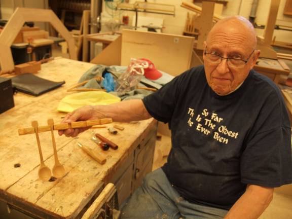 Don Scott of Sparta working on a carved spoon collection.