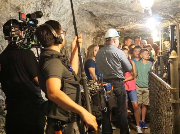The TLC camera and sound crew, on left, film Sterling Hill Mining Museum CEO Bill Kroth, center, as he gives the tour.