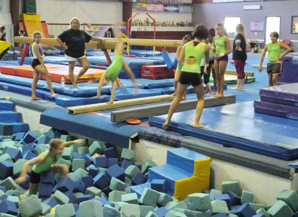 Westys founder Danielle Oehrlich (white shorts) observes gymnasts in action.
