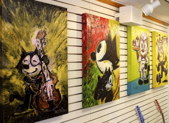 Felix the Cat paintings by Don Oriolo hang in his new shop in Lafayette Village. Photo by Joe Hicks