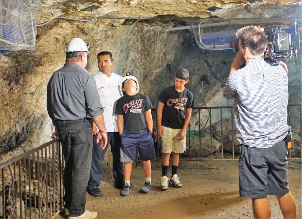 CEO Bill Kroth, on left, gives tour to Buddy Valastro and sons while being filmed for the Cake Boss show.