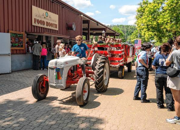 <b>The tractor parade through the fair Saturday, Aug. 2. (Photo by Nancy Madacsi)</b>.
