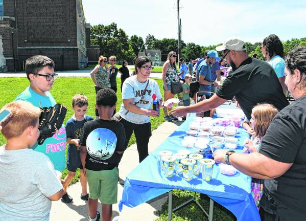 Parents and children get ice cream.