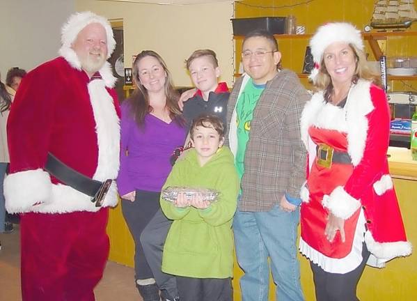 Santa Collins with the Velasco Family at Christmas Dinner with Mrs. Santa Collins
