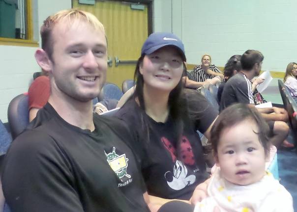 Baby Ivan, 8 months old, attended the school board meeting with his parents, Alex and Yuna Smith (Photo by Frances Ruth Harris)