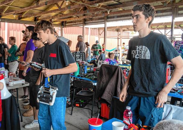 <b>Fair-goers watch battling robots Saturday, Aug. 2. (Photo by Nancy Madacsi)</b>.