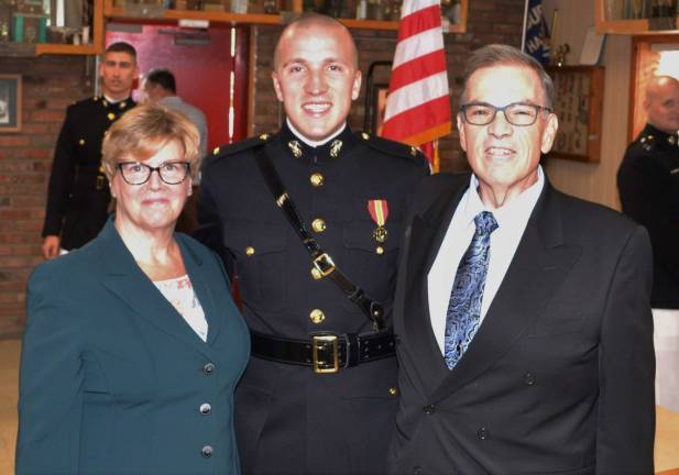 Marine 2nd Lt. John R. Rueckel III with his father, John Rueckel, and Kathleen Crawford-Rueckel.