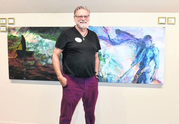 David Derr stands next to his favorite painting Realising the Fury.