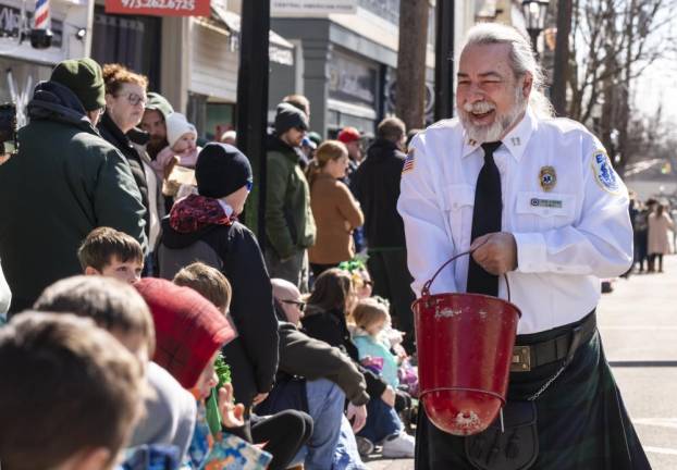 Captain John Strowe, an emergency medical technician from Lafayette, hands out candy during the parade.