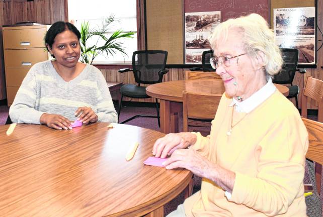 Shibi John of Ogdensburg and Annette Fritt of Franklin are shown doing origami.