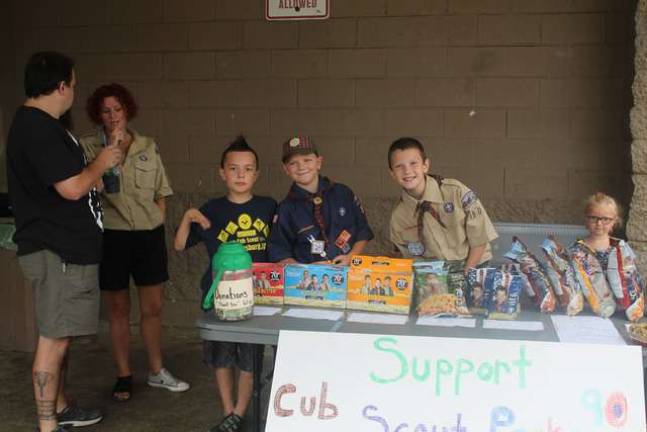 Cub Scouts from Franklin's Pack 90 kick off their scouting season with a popcorn fund raiser. Scout Leader Kelly Postas supervises as scouts Elijah, Tony and Mitchell work their popcorn sale skills in front of Franklin WalMart.