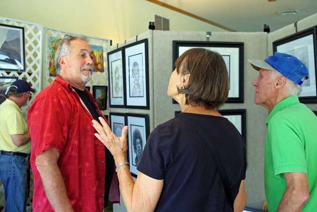 At left, illustrator Bruce Young has mastered portraits and also paints a variety of other subjects. This year's offerings included a self-portrait.