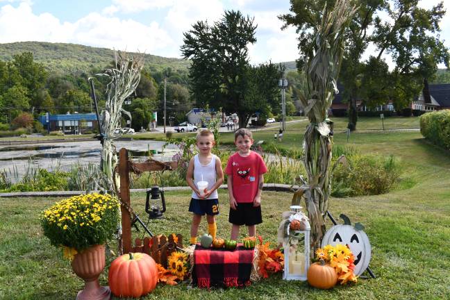 <b>Dougie Morrica and Conner Minter of Vernon pose in front of a fall display at the Vernon Street Fair on Saturday, Sept. 13. (Photo by Maria Kovic)</b>