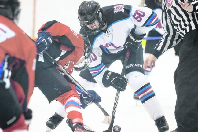 Junior Ty Dellicker (50) of Newton/Lenape Valley battles for the puck on a faceoff.