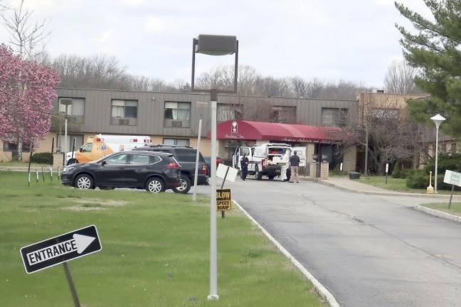 Ambulance crews are parked outside Andover Subacute and Rehabilitation Center in Andover on April 16. Police responding to an anonymous tip found more than a dozen bodies at the nursing home. (AP Photo/Ted Shaffrey)