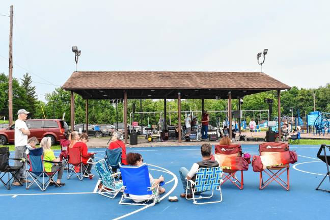 Residents listen to the musicians.