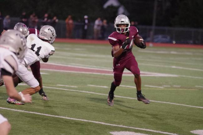 Newton running back DeMarius Posey breaks to the outside with the ball during a play. Posey gained 121 yards on the ground and scored one touchdown in the contest.