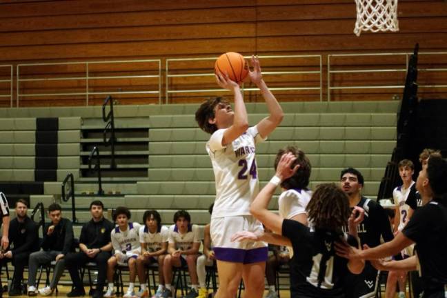 Warwick Valley's Jake Cosco rises toward the hoop during a shot.