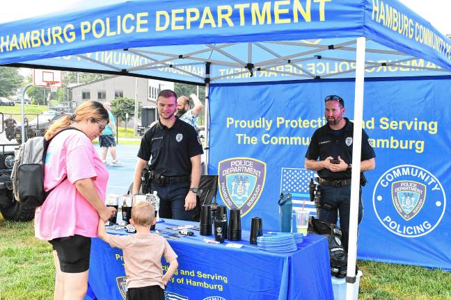 Residents talk to Hamburg police officers during the National Night Out event Tuesday, Aug. 5 in Franklin.