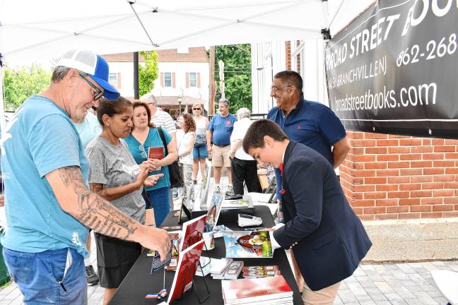 Zy Saturnees, 11, signs his book, ‘Jill the Chick,’ on Saturday, July 26 outside Broad Street Books in Branchville.