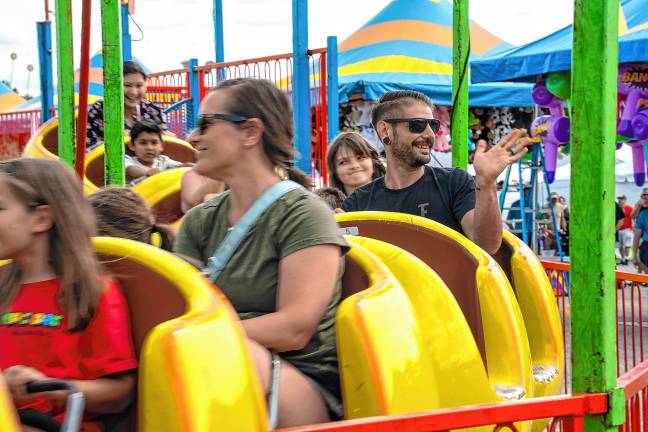 <b>Fair-goers take a ride Saturday, Aug. 2. (Photo by Nancy Madacsi)</b>.