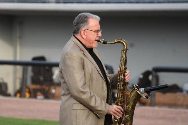 David Demsey, coordinator of jazz studies at William Paterson University, performs the Star Spangled Banner on the saxophone.