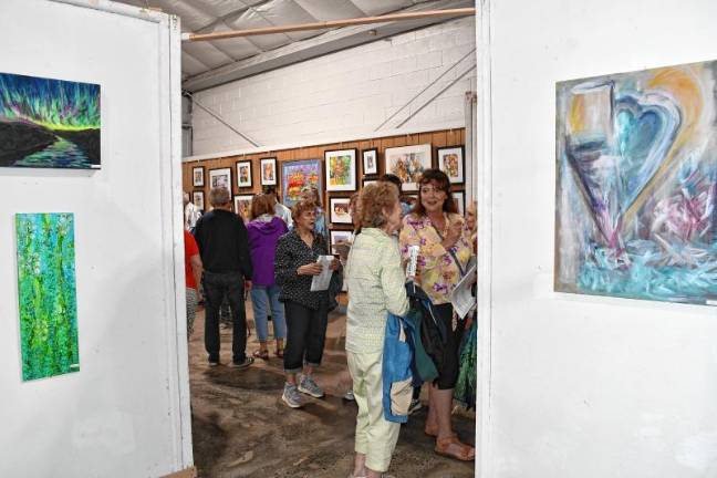 <b>Residents look at the Art in Sussex County show during a Meet the Artists reception Thursday evening, July 31 in the Richards Building at the Sussex County Fairgrounds in Augusta. (Photo by Maria Kovic)</b>