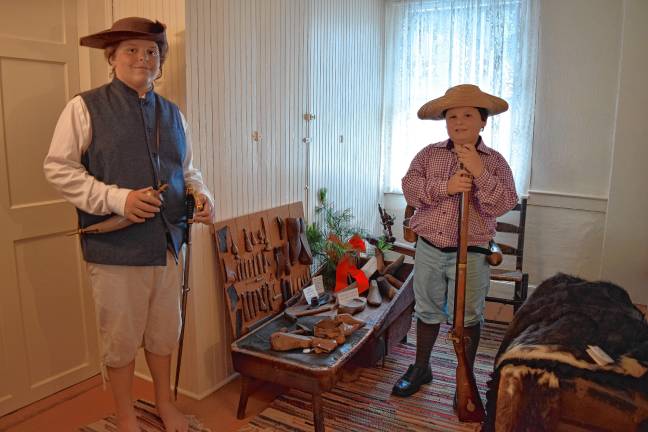 <b>The Ziccardi brothers August, 11, and Heath, 10, by a cobbler’s bench with tools and old shoes in the DAR Van Bunschooten Museum in Wantage. (Photos by Theresa Esposito)</b>