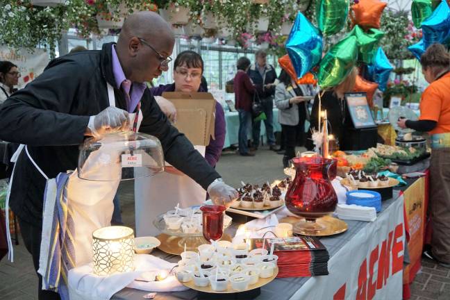 PHOTOS BY VERA OLINSKI Bakery Manager Arthur Shanklin adds finishing touches to the "Best Presentation."