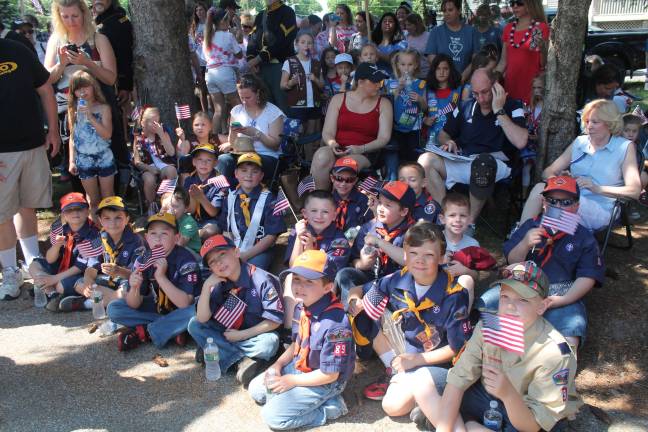 Pack 90 Cub Scouts rest after marching.