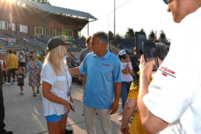 <b>Jack Ciattarelli, center, greets a supporter inside the ballpark.</b>