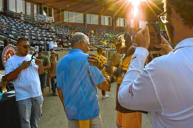 <b>Jack Ciattarelli, center, shakes hands with the Miner Man at Skylands Stadium.</b>