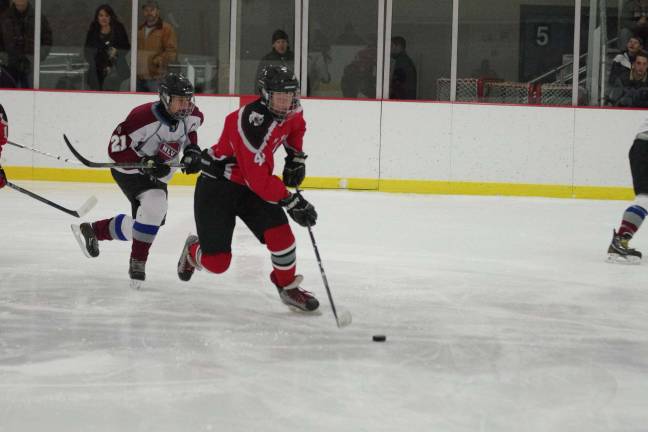 High Point-Wallkill Valley's Tucker Eckert reaches for the puck.