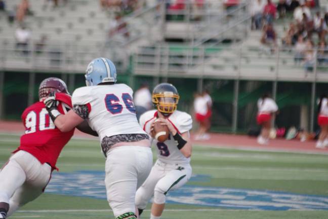 West offensive lineman Jake Vogel #66 (Sparta) protects quarterback Aaron Furnbach #9 (West Milford).