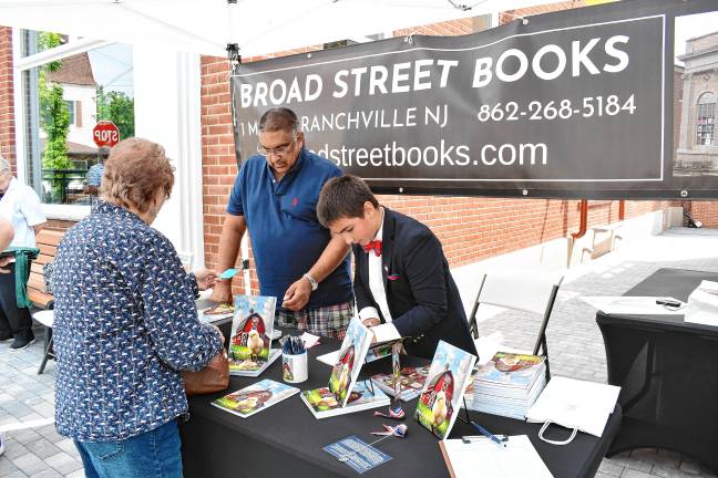 ZS1 Zy Saturnees, 11, signs his book, ‘Jill the Chick,’ on Saturday, July 26 outside Broad Street Books in Branchville. (Photos by Maria Kovic)