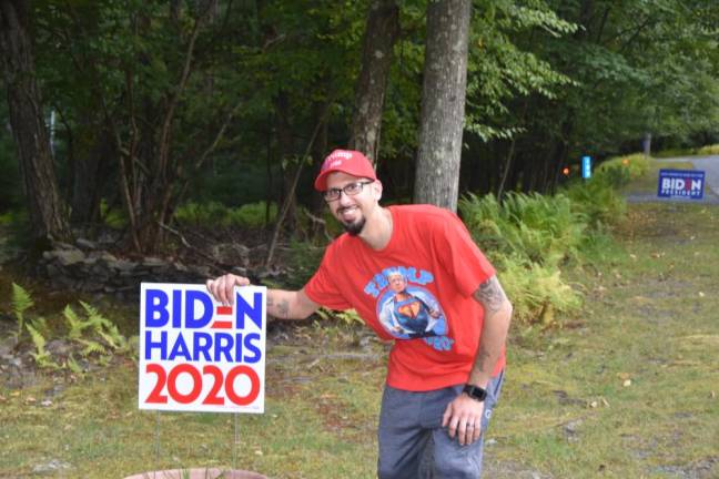 Trump supporter Chris Watkins at home in Milford, Pa., with the sign his wife put up that day. (Photo by Becca Tucker)