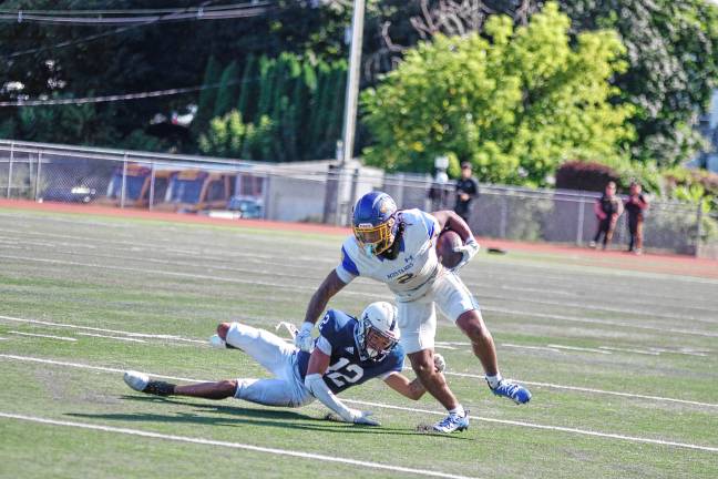 <b>A Monroe ball carrier tries to evade a Sussex defender.</b>